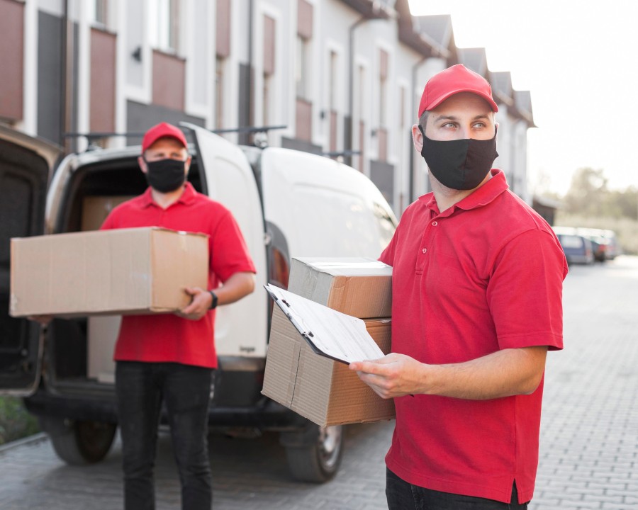 Professional delivery staff collecting and delivering laundry for doorstep service